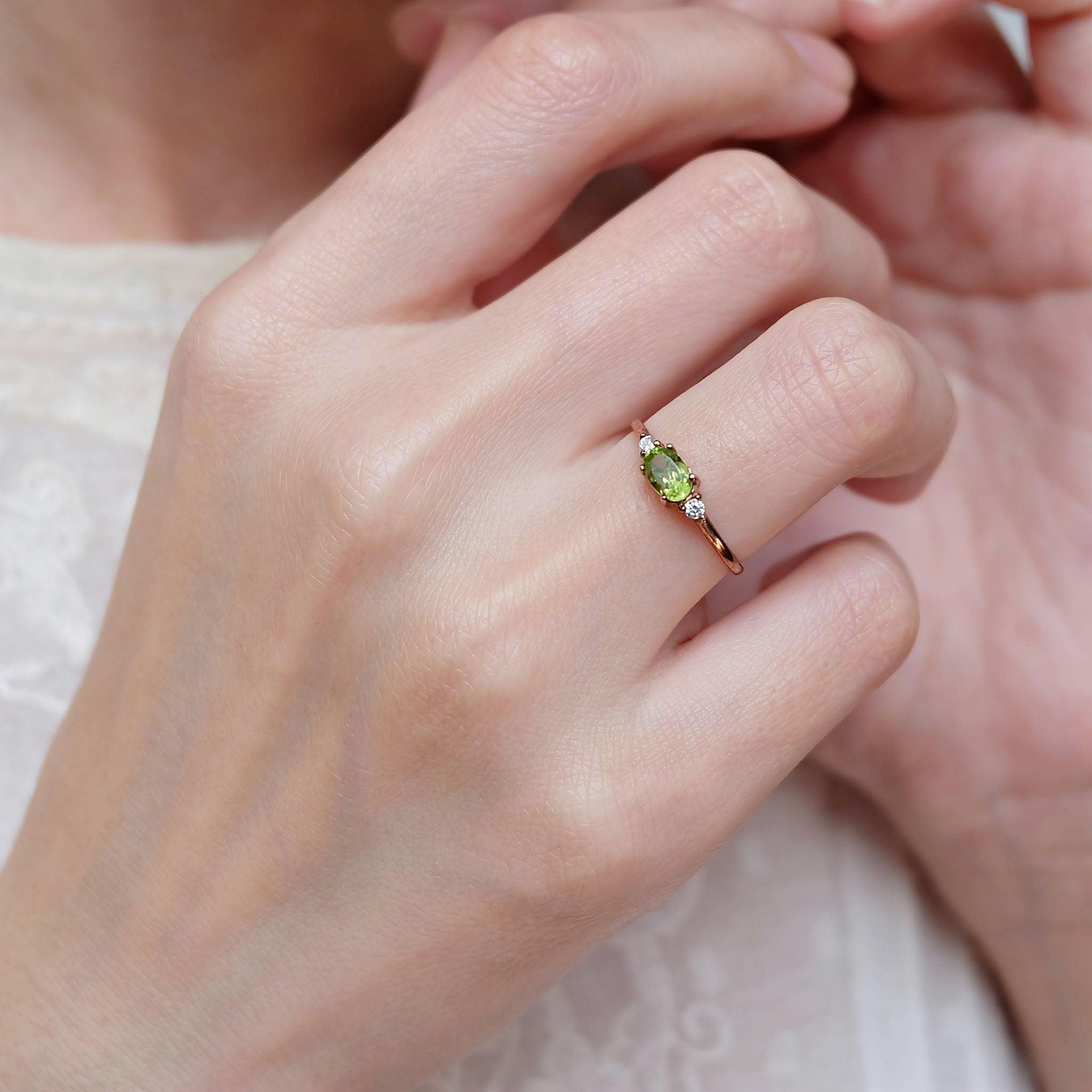 A peridot diamond ring worn on the right hand